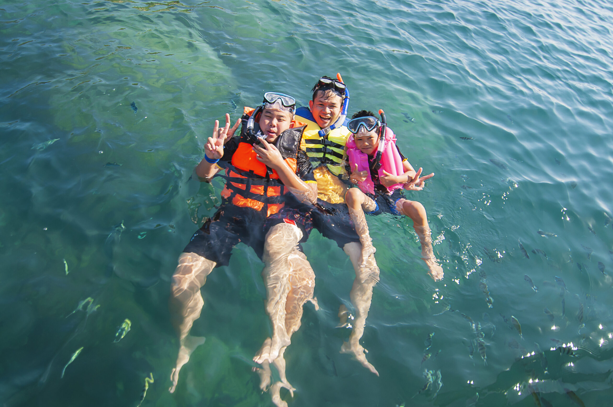 Three guys floating happily in the sea water